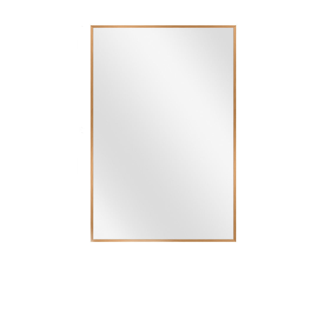 slim gold framed wall mirror over single sink